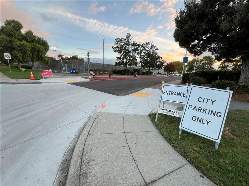 The parking lot entrance to the lot adjacent to The Vibe. 